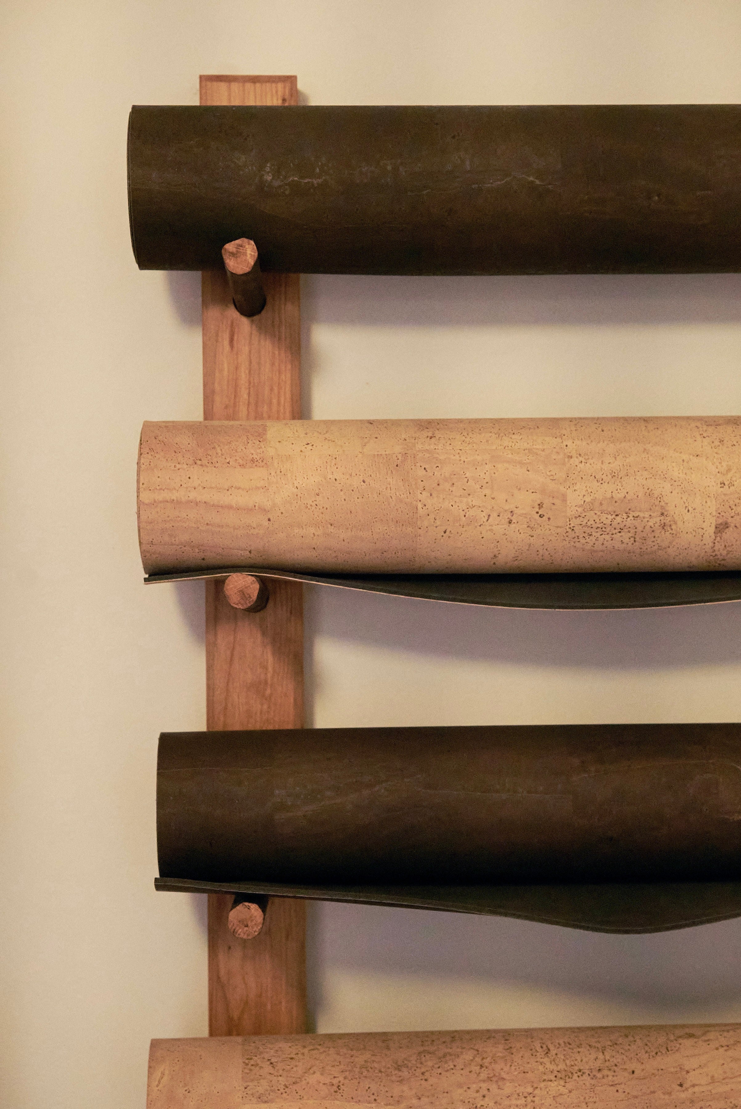Rituil cork leather yoga mats rolled up on a studio wall