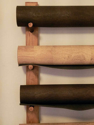 Rituil cork leather yoga mats rolled up on a studio wall