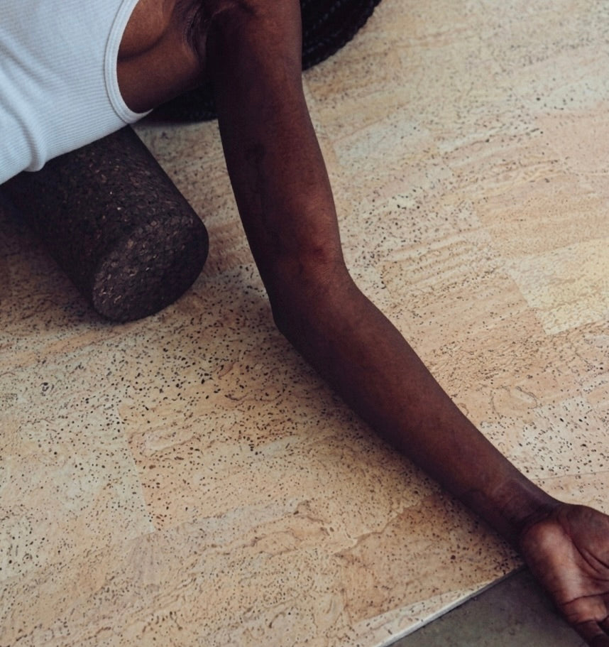 woman using Rituil cork roller on back