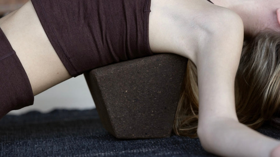 woman laying on ritul cork yoga block