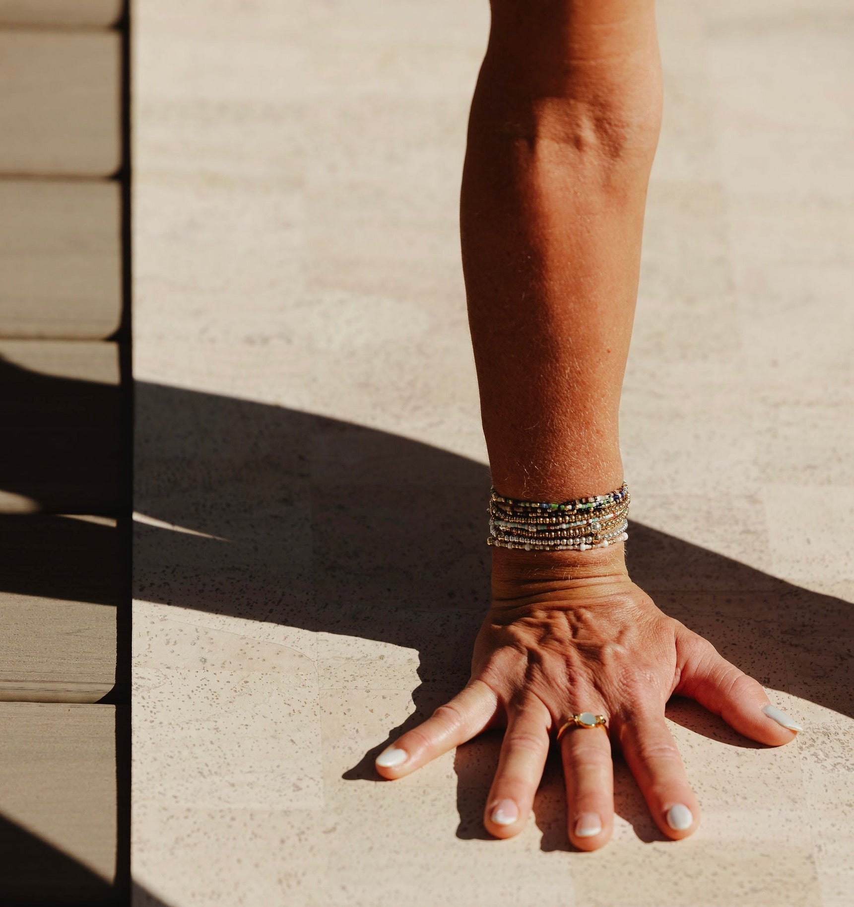 Rituil sustainable cream cork leather yoga mat featuring a non-slip, non-toxic, pvc free, with woman's hand gripping mat
