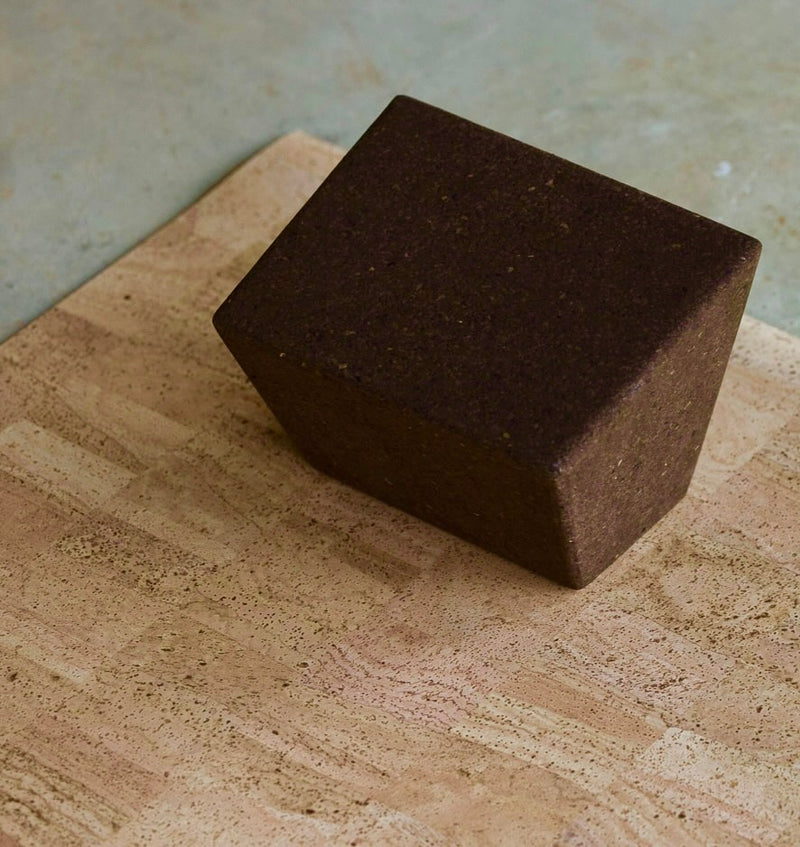 earth or brown restorative yoga block on sand mat