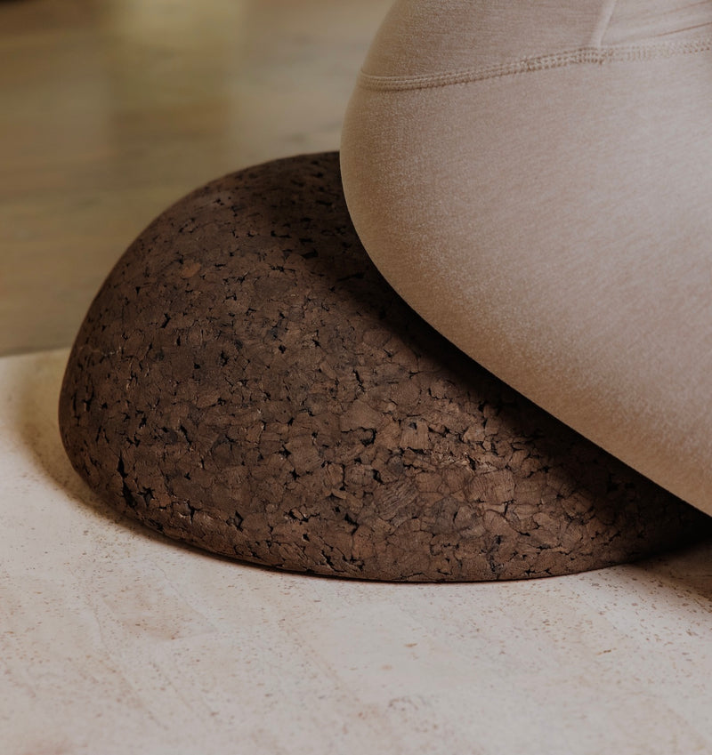 woman sitting on top of a cork meditation seat