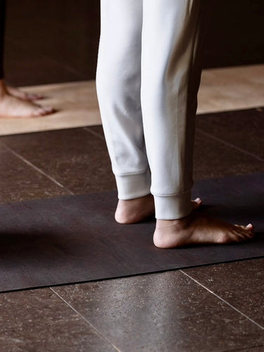 womans feet on natural rituil cork earth mat  #color_earth