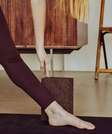 Set of two earthy cork yoga blocks by rituil, showing textured surface and rectangular shape for improved yoga stability and support.