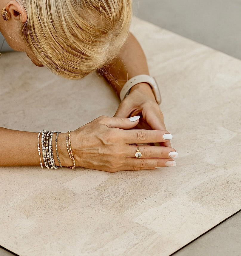 Cork yoga mat non-slip grip light color with woman in childs pose Rituil #color_bone