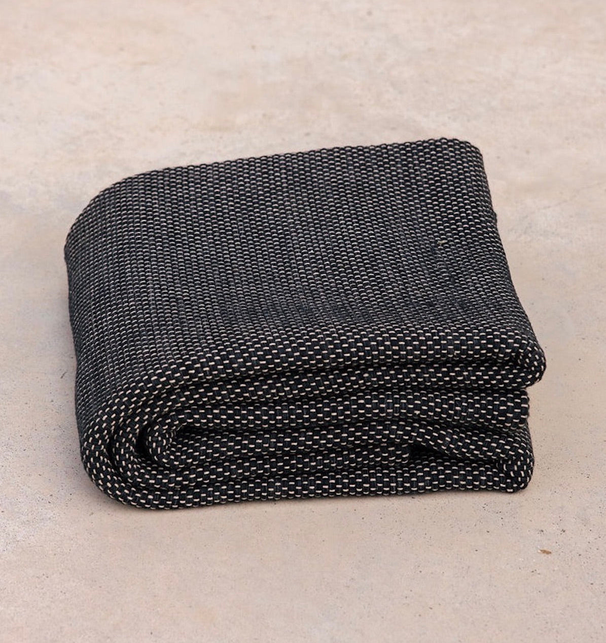 folded Rituil recycled cotton yoga rug in ash or black color #color_ash