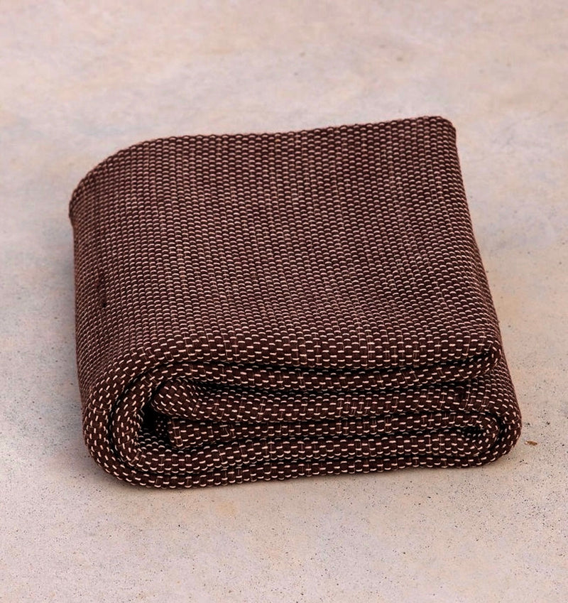 folded Rituil natural non slip recycled cotton yoga rug in earth or brown color #color_earth