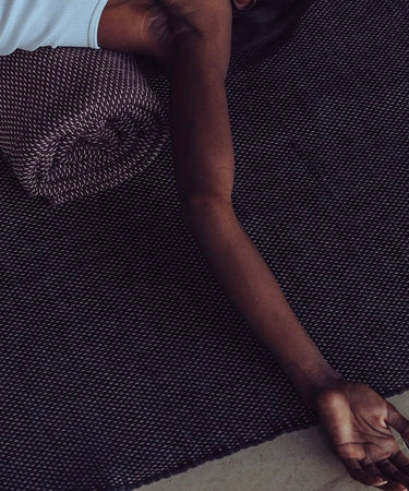 Rituil restorative yoga rug in ash color, soft and textured yoga rug designed for gentle yoga and relaxation sessions.