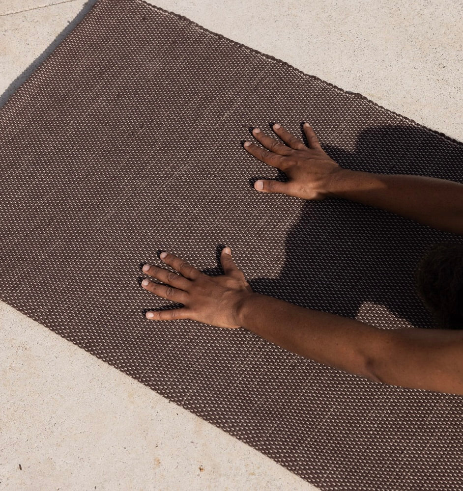woman practicing yoga on Rituil cotton yoga rug