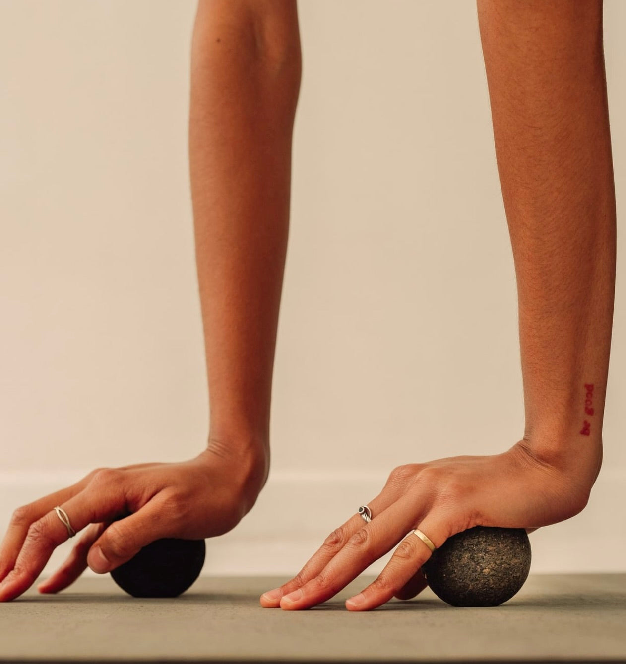 Rituil sustainable Portuguese cork massage balls for yoga, Pilates core workouts, and deep tissue muscle recovery shown on cork yoga mat with hand pressing in to balls