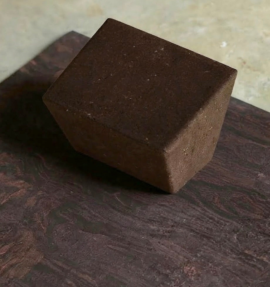 rituil restorative yoga set with earth cork mat and brown restorative block on concrete floor