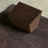 rituil restorative yoga set with earth cork mat and brown restorative block on concrete floor