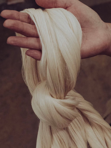 woman holding raw linen in her hands from Portugal 